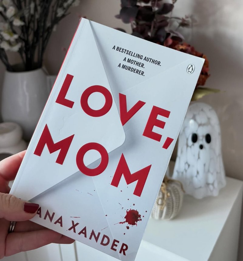 Fliss holding her copy of Love, Mom by Iliana Xander